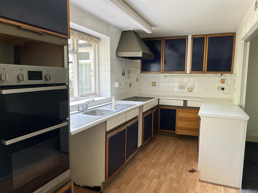 Lot: 2 - DETACHED THREE-BEDROOM HOME FOR IMPROVEMENT WITH COUNTRYSIDE VIEWS - Fitted kitchen with laminate floor and white wall tiles